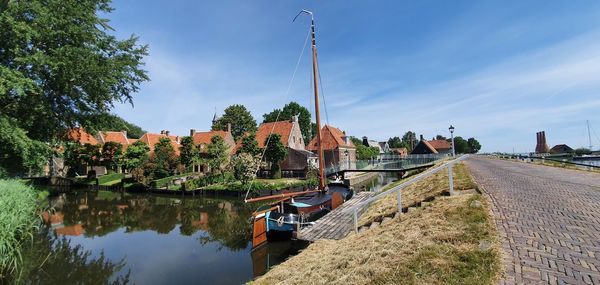 Panoramic view of  canal amidst buildings against sky