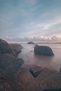 Scenic view of sea against cloudy sky