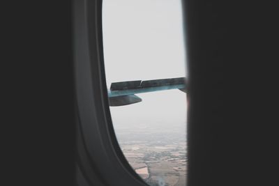 Close-up of airplane wing seen through window