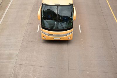High angle view of yellow bus on road