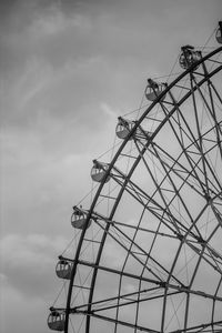 Low angle view of ferris wheel against sky