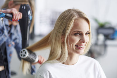 Portrait of happy woman at the hairdresser's