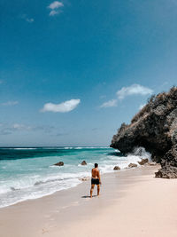 People on beach against sky