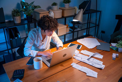 High angle view of woman using digital tablet at home