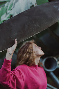 Rear view of woman holding umbrella