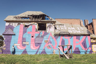 Graffiti on building against clear sky