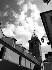 Low angle view of building against cloudy sky