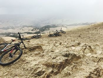 Bicycle on mountain against sky