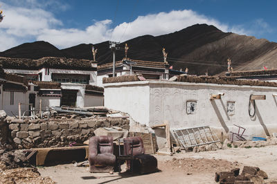 Construction site by buildings against sky