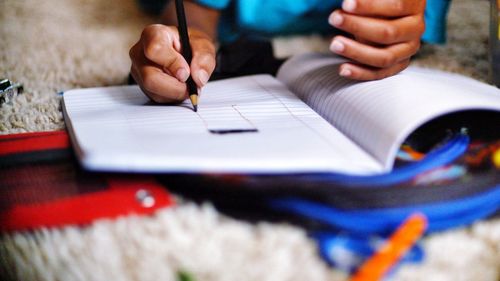 Close-up of man working on paper