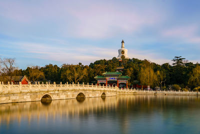 View of bridge over river against cloudy sky