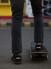 Low section of man walking on street