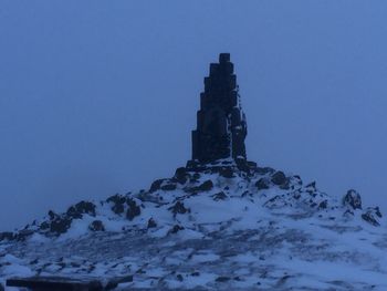 Built structure on snow against sky