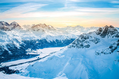 Scenic view of snowcapped mountains against sky during sunset