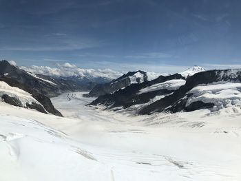 Scenic view of snow covered mountains against sky