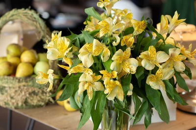 Close-up of yellow day lilies in vase at home