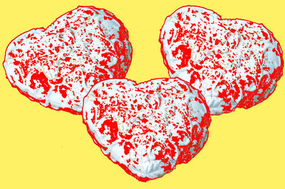 Close-up of heart shape against red background