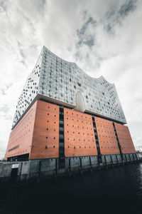 Low angle view of building against cloudy sky