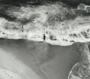 High angle view of man walking at beach