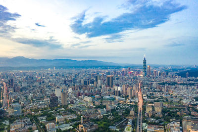 High angle view of city against cloudy sky