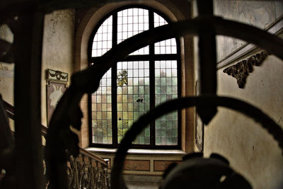 Silhouette man seen through window