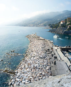 Pier of the touristic harbor of the sea village of camogli, liguria, that faces paradise bay 