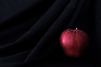 Close-up of apple on black background