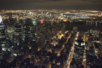 High angle view of illuminated city buildings at night