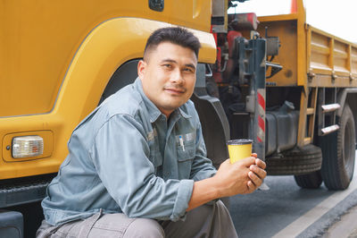 Portrait of young man sitting in car