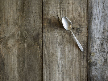 Directly above shot of abandoned spoon on old table