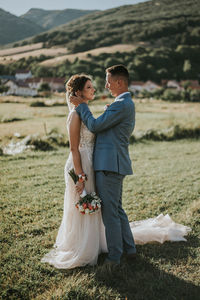 Rear view of couple holding hands