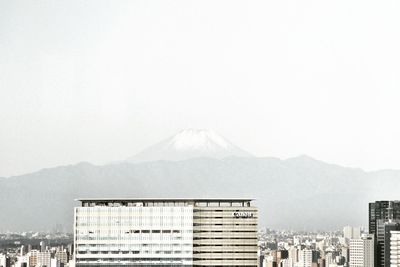 View of buildings on mountain against sky