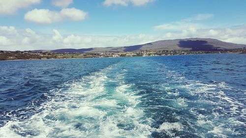Scenic view of sea against blue sky