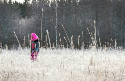 Woman standing on grassy field