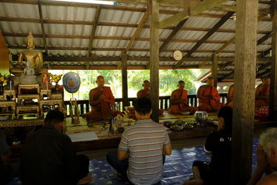 Rear view of people sitting in corridor