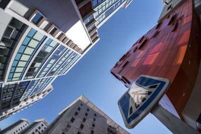 Low angle view of buildings against clear blue sky