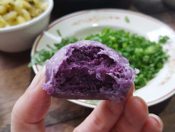 Cropped hand of person holding food