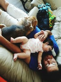 Man with baby and two dogs at home