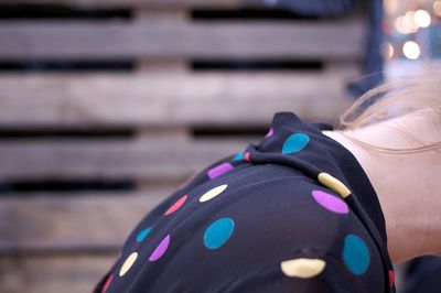 Midsection of woman wearing colorful polka dots top