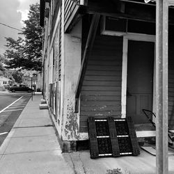 Empty road amidst buildings in city