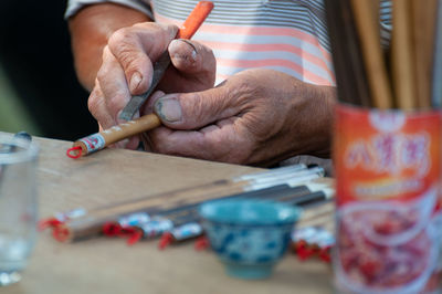 Close-up of man preparing food on table