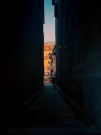 Empty alley amidst buildings in city