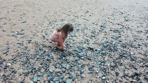 Full length of girl on pebbles at beach