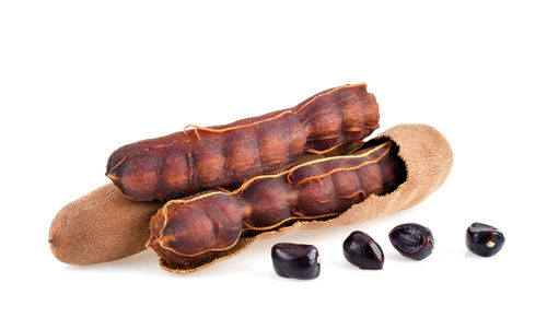 Close-up of coffee beans against white background