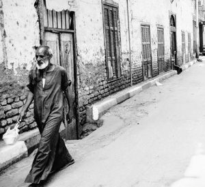 Street amidst buildings in city during winter
