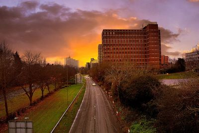 Road against cloudy sky at sunset