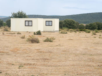 Built structure on field against sky