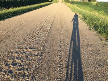 Shadow of cyclist on country road