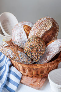 Selection of freshly baked organic sourdough loafs of bread in basket.