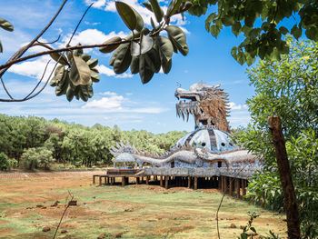 Built structure by trees against sky